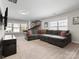 Large living room featuring a comfortable sectional couch, carpet, and a basketball game at 4028 Shadowbrook Rd, Waxhaw, NC 28173