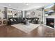 Open-concept living room featuring a fireplace, TV, and sectional couch at 4028 Shadowbrook Rd, Waxhaw, NC 28173