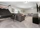 Spacious living area with comfortable seating, carpet, and a unique basketball game feature at 4028 Shadowbrook Rd, Waxhaw, NC 28173