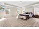 Spacious main bedroom featuring a tray ceiling, large bed, and ample natural light at 4028 Shadowbrook Rd, Waxhaw, NC 28173