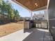 Covered outdoor kitchen featuring a built-in grill, stainless steel appliances, and a stone facade at 4028 Shadowbrook Rd, Waxhaw, NC 28173
