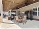 Cozy covered patio featuring dining table, comfortable seating, ceiling fans, and an outdoor living area with a TV at 4028 Shadowbrook Rd, Waxhaw, NC 28173