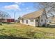 View of the back of the home, showcasing a spacious yard and a wooden deck area at 406 E 29Th St, Kannapolis, NC 28083
