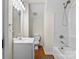 A clean bathroom with white fixtures, a wood-look floor, and a combined shower and bathtub at 406 E 29Th St, Kannapolis, NC 28083