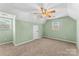 A bedroom featuring carpet, large windows for natural light, and a ceiling fan for comfort at 406 E 29Th St, Kannapolis, NC 28083