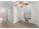 Carpeted bonus room offers a unique storage nook and a ceiling fan for added comfort at 406 E 29Th St, Kannapolis, NC 28083