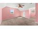 A bright bedroom featuring carpeted floors, a ceiling fan, and windows that let in plenty of light at 406 E 29Th St, Kannapolis, NC 28083