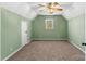 A bright bedroom with carpet, a large window for natural light, and a ceiling fan for comfort at 406 E 29Th St, Kannapolis, NC 28083