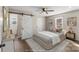 Serene bedroom featuring a sliding barn door, ceiling fan, and cozy decor at 406 E 29Th St, Kannapolis, NC 28083