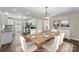 Open-concept dining area featuring a table with white chairs adjacent to a modern kitchen at 406 E 29Th St, Kannapolis, NC 28083