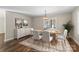 Elegant dining room with a wood table set for six, complemented by a stylish chandelier at 406 E 29Th St, Kannapolis, NC 28083