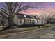 Charming home featuring a front porch, dormer windows, and a well-maintained lawn at sunset at 406 E 29Th St, Kannapolis, NC 28083