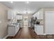 Bright kitchen with white cabinets, stainless steel appliances, and wood-look floors at 406 E 29Th St, Kannapolis, NC 28083