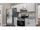 Close up of the stainless steel refrigerator and stove with granite countertops at 406 E 29Th St, Kannapolis, NC 28083