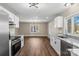 Modern kitchen features white cabinets, stainless steel appliances, and granite countertops at 406 E 29Th St, Kannapolis, NC 28083