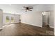 Bright living room with wood-look floors, ceiling fan, and backyard access at 406 E 29Th St, Kannapolis, NC 28083