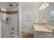 Bright bathroom with a tub, and vanity with double sinks and neutral color palette at 4117 Tyng Way, Charlotte, NC 28211