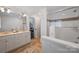 Bright bathroom featuring double sinks, a separate shower, and neutral tile at 4117 Tyng Way, Charlotte, NC 28211