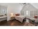 Stylish bedroom with vaulted ceiling, dormer window, built-in shelves, and hardwood floors at 4117 Tyng Way, Charlotte, NC 28211