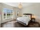 Cozy bedroom with a large window, hardwood floors, and chandelier lighting at 4117 Tyng Way, Charlotte, NC 28211