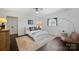 Clean bedroom featuring hardwood floors, a comfy chair, and a large window at 4117 Tyng Way, Charlotte, NC 28211