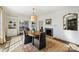 Elegant dining room with a decorative fireplace, beautiful rug, and a dark wood table at 4117 Tyng Way, Charlotte, NC 28211