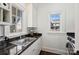 Functional laundry room features granite counters, a stainless sink, and natural light at 4117 Tyng Way, Charlotte, NC 28211
