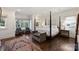Elegant main bedroom with a four-poster bed, large windows, and hardwood floors at 4117 Tyng Way, Charlotte, NC 28211