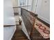 Traditional staircase with decorative iron railing and dark hardwood steps at 4117 Tyng Way, Charlotte, NC 28211
