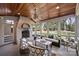 Inviting sunroom with fireplace, wood ceiling, and large windows showcasing the outdoor greenery at 4117 Tyng Way, Charlotte, NC 28211