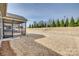 Backyard featuring a screened-in porch and a sloped lawn at 4521 Middlebury Ln, Fort Mill, SC 29715