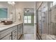 Bathroom featuring double sinks, vanity, and glass shower with tile surround at 4521 Middlebury Ln, Fort Mill, SC 29715