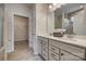 Bathroom featuring double sinks with modern hardware and an adjacent walk-in closet at 4521 Middlebury Ln, Fort Mill, SC 29715