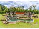 The attractive entrance to Carolina Orchards features stonework, cascading water features and lush landscaping around the community sign at 4521 Middlebury Ln, Fort Mill, SC 29715
