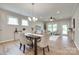 Dining space showcasing an elegant chandelier, hardwood floors, natural light, and modern furnishings that enhance the home's ambiance at 4521 Middlebury Ln, Fort Mill, SC 29715