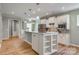 Bright kitchen features white cabinets, stainless steel appliances, and an island with bar seating at 4521 Middlebury Ln, Fort Mill, SC 29715