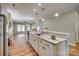 Bright kitchen features an island with granite countertops, stainless steel appliances, and open floor plan at 4521 Middlebury Ln, Fort Mill, SC 29715