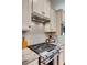 Gourmet kitchen features a stainless steel stove, tile backsplash, and granite countertops at 4521 Middlebury Ln, Fort Mill, SC 29715