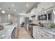 Modern kitchen features stainless steel appliances, marble counters, an island, and open layout at 4521 Middlebury Ln, Fort Mill, SC 29715