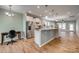 Open-concept kitchen with stainless steel appliances, white cabinets, and a breakfast bar at 4521 Middlebury Ln, Fort Mill, SC 29715