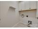 Functional laundry room featuring tile flooring, overhead cabinets, and hookups at 4521 Middlebury Ln, Fort Mill, SC 29715