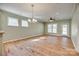 Bright living area featuring hardwood floors, a chandelier, and large windows at 4521 Middlebury Ln, Fort Mill, SC 29715