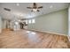 Open-concept living room showcases hardwood floors and a view of the modern kitchen at 4521 Middlebury Ln, Fort Mill, SC 29715