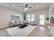 Cozy living room showcasing hardwood floors, neutral-toned decor, a ceiling fan, and natural light streaming through the windows at 4521 Middlebury Ln, Fort Mill, SC 29715