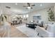 Open concept showcasing living, dining, and kitchen areas with hardwood floors, natural light, and stylish contemporary furnishings at 4521 Middlebury Ln, Fort Mill, SC 29715
