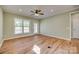 Bright living room featuring hardwood floors, fan, and a glass door leading outside at 4521 Middlebury Ln, Fort Mill, SC 29715