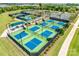 Overhead view of a multiple pickleball courts with green and blue surfaces, enclosed by black fencing for community recreational use at 4521 Middlebury Ln, Fort Mill, SC 29715