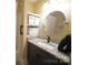 Bathroom featuring a granite countertop, dark vanity, and a large round mirror at 4531 Landmark Dr, Rock Hill, SC 29732