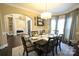 Elegant dining room features a stylish chandelier, large window with curtains, and archway to another room at 4531 Landmark Dr, Rock Hill, SC 29732