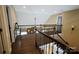 Open loft space featuring a wood railing, wood floors and a peek into another room at 4531 Landmark Dr, Rock Hill, SC 29732